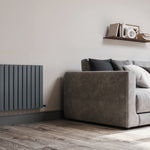Modern living room with a gray sofa, wooden floor, and wall-mounted radiator.
