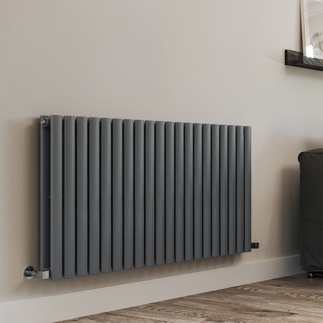 Gray radiator on a beige wall with a wooden floor