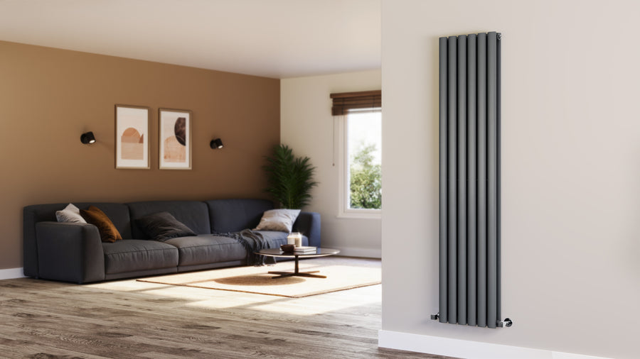 Living room with a gray sofa, coffee table, and a tall black radiator on a white wall.