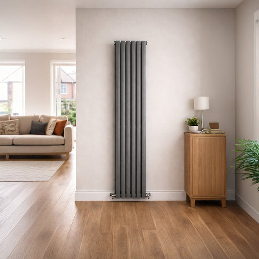 Tall vertical radiator in a living room with wooden floor and light-colored walls.