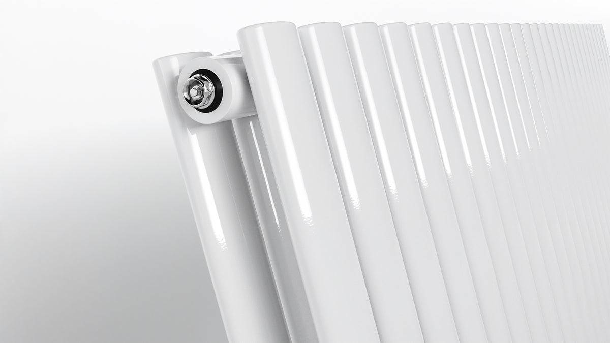 Close-up of oval tube detail on white vertical radiator